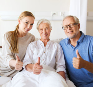 elderly couple and female caregiver