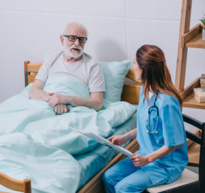 elderly man talking to his caregiver